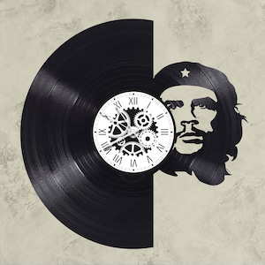 May include: A black vinyl record clock with a white clock face featuring gears and Roman numerals. The clock is partially obscured by a black and white silhouette of a man with a star on his hat.