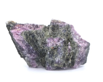 May include: A rough, dark gray and purple rock with a crystalline texture. The rock has a natural, unpolished appearance.