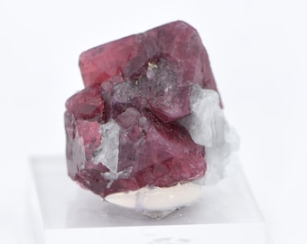 May include: A cluster of deep red spinel crystals with a slightly cloudy appearance. The crystals are arranged in a cluster and have a rough, natural texture.
