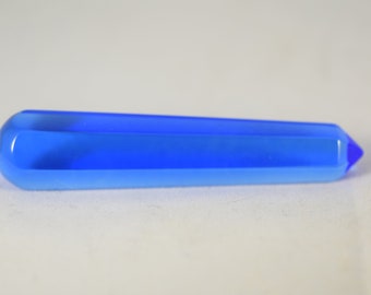 May include: A smooth, light blue crystal point with a pointed tip.
