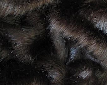 May include: Close-up of a dark brown faux fur fabric. The fur is soft and fluffy, with a slightly iridescent sheen.