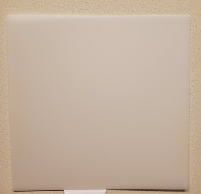 May include: A white cutting board with a smooth surface.