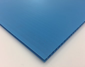 May include: A close-up of a blue corrugated plastic sheet. The sheet is made of a lightweight, durable material and has a smooth, flat surface.