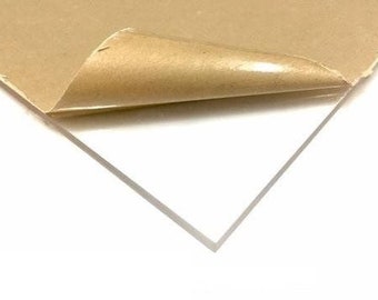 May include: A clear acrylic sheet with a protective brown paper backing. The paper is partially peeled back to reveal the smooth, transparent surface of the acrylic.