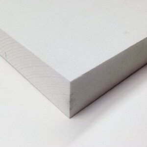 May include: A close-up of a white foam board, showing the smooth surface and the edges of the board.