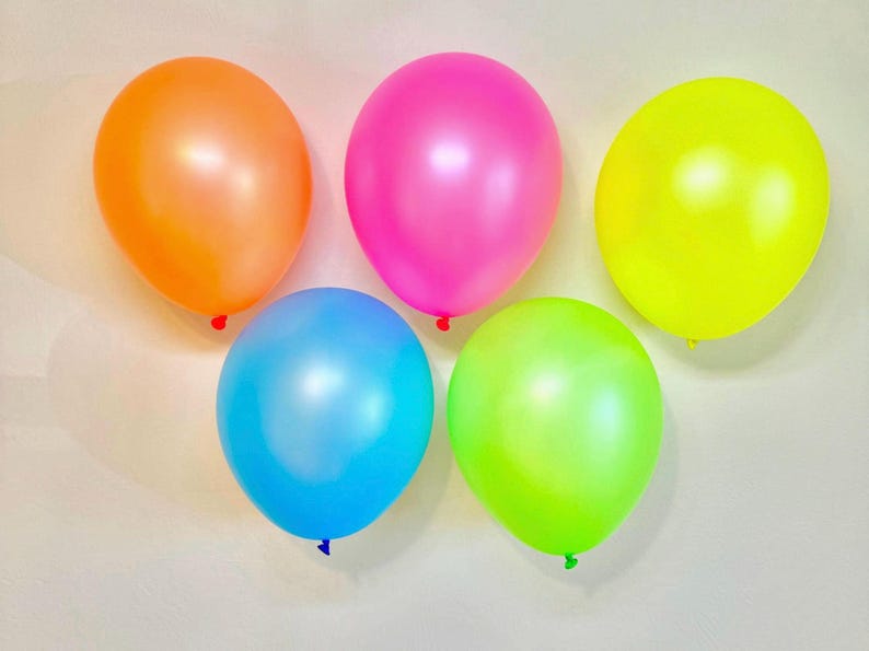 May include: Five balloons in different colours: orange, pink, yellow, light blue, and lime green. The balloons are all shiny and have a pearlescent finish.