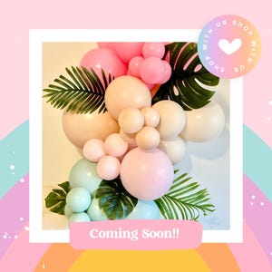 K&ouml;nnte beinhalten: Ein Ballonbogen aus pastellrosa, beige und hellblauen Ballons mit gr&uuml;nen tropischen Bl&auml;ttern. Der Text "Coming Soon!" befindet sich am unteren Rand des Bildes.