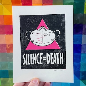 May include: Black and pink print with a white face mask with the text "KN95" on it. The print has the text "SILENCE=DEATH" and the artist's signature "robin finn".
