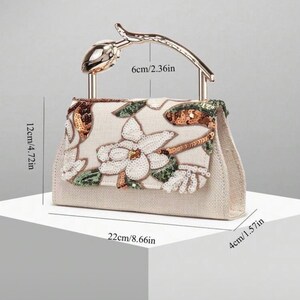 May include: A beige handbag with a floral sequin pattern, featuring a gold-tone metal handle shaped like a flower bud. Dimensions are 8.66 inches wide, 4.72 inches high, 1.57 inches deep, with a 2.36 inch handle height.