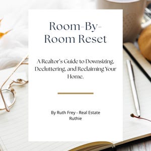 May include: An open notebook with a book titled "Room-By-Room Reset" on top. The book's subtitle reads "A Realtor's Guide to Downsizing, Decluttering, and Reclaiming Your Home." A pen, glasses, and a mug are also visible.