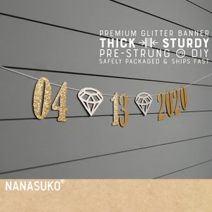 May include: Gold glitter banner with the numbers 04 13 2020 and white diamond shapes. The banner is pre-strung and says "Premium Glitter Banner Thick Sturdy Pre-Strung DIY Safely Packaged & Ships Fast".