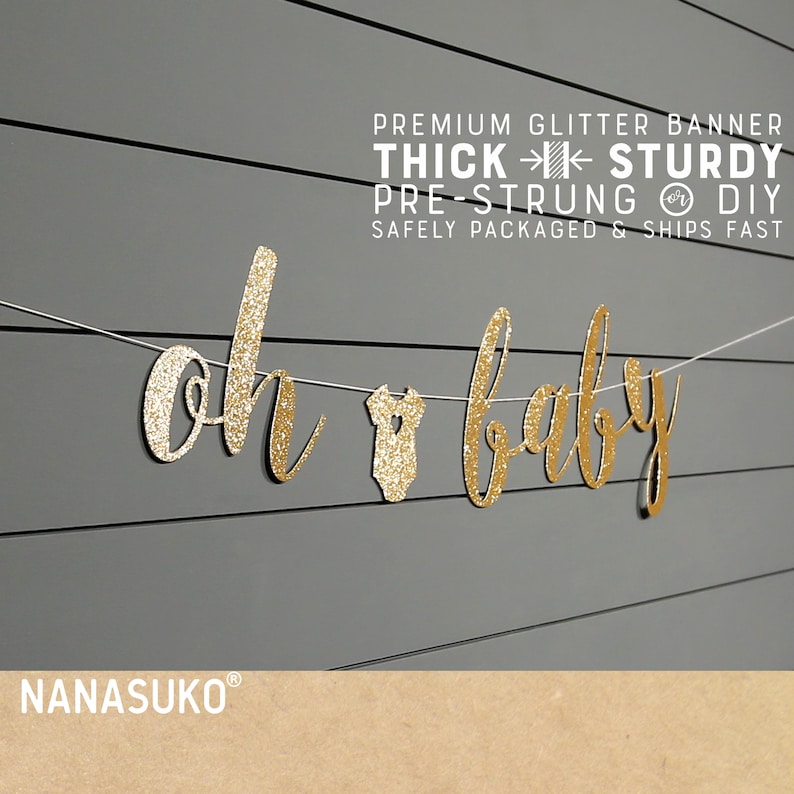 May include: Gold glitter banner that reads "Oh Baby" with a small baby onesie in the middle. The banner is pre-strung and comes with instructions for DIY assembly.  The banner is thick and sturdy, and is safely packaged and ships fast.  The banner is from the shop NANASUKO.