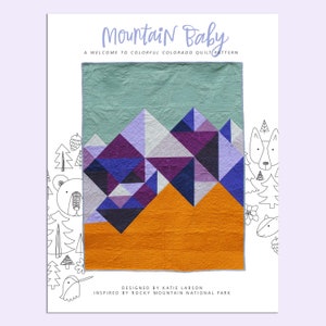 Modern geometric baby quilt with mountains, triangles and bright colors.