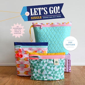 May include: Three zippered pouches in different sizes and patterns. The largest pouch is turquoise with a white geometric pattern. The medium pouch is pink, white, and orange with a geometric pattern. The smallest pouch is green with a white geometric pattern. The text "LET'S GO! SINGLE GUSSET BAG IN 5 SIZES" is on a blue tag. The text "PDF PATTERN" is on a white circle.