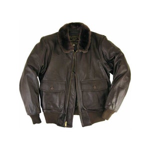 May include: A brown leather bomber jacket with a fur collar. The jacket has two flap pockets and a zip closure.