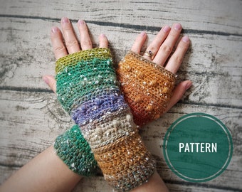 May include: A pair of fingerless crochet gloves featuring a textured bobble stitch pattern. The gloves display a variegated color gradient transitioning from green and purple to brown and orange, with white flecks throughout. A green circle with the text PATTERN.