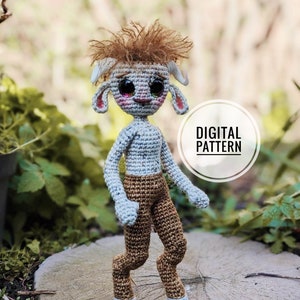May include: Crochet pattern for a cute, amigurumi creature with brown hair, a white body, brown pants, and hooves. The creature has large, round eyes and a friendly expression. The pattern is digital and includes instructions for making the creature.