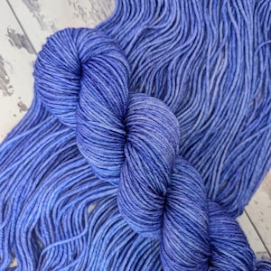 May include: A skein of blue yarn with a subtle gradient of colour. The yarn is soft and fluffy, and it is perfect for knitting or crocheting.