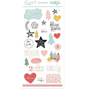 May include: A sheet of Christmas-themed stickers with a variety of designs, including stars, trees, hearts, and text in Spanish. The text includes phrases like "Momentos para el Recuerdo", "No hay mejor lugar que el hogar", "felices fiestas", and "2022 ilusión".