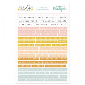 May include: A sheet of colorful puffy stickers with Spanish phrases like "Las Primeras Flores" (The First Flowers), "Mi Vida" (My Life), and "Alegría" (Joy). The stickers are on a white background with a dotted pattern.