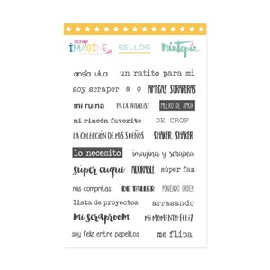 May include: A sheet of 16 black and white rubber stamps with Spanish phrases related to scrapbooking. The phrases include "ansia viva", "soy scraper", "mi ruina", "mi rincon favorito", "la coleccion de mis suenos", "lo necesito", "super cuqui", "mis compritas", "lista de proyectos", "mi scraproom", "soy feliz entre papelitos", "un ratito para mi", "amigas scraperas", "pa la wishlist", "muero de amor", "de crop", "shaker, shaker", "imagina y scrapea", "adorable", "super fan", "de taller", "poniendo orden", "arrasando", "mi momento feliz", "me flipa".