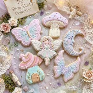 May include: A collection of decorated sugar cookies featuring a fairy, two butterflies, two mushrooms, and a crescent moon with a face. The set includes a sign reading The Pixie Dust Collection and two small glass vials labeled Pixie Dust.