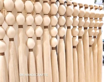 May include: A collection of long, cream-colored strands of hair, tied together in bundles with brown string, and hung on a metal rack. The strands are arranged in rows, with each row containing multiple bundles. The text "SN HANDICRAFTS" is visible at the bottom of the image.