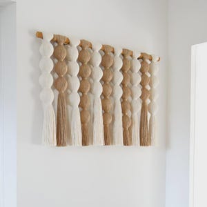 May include: A rustic wooden sign with the text "Welcome to our home" in white lettering. The sign features a distressed finish and a simple, inviting design, perfect for front door decor.