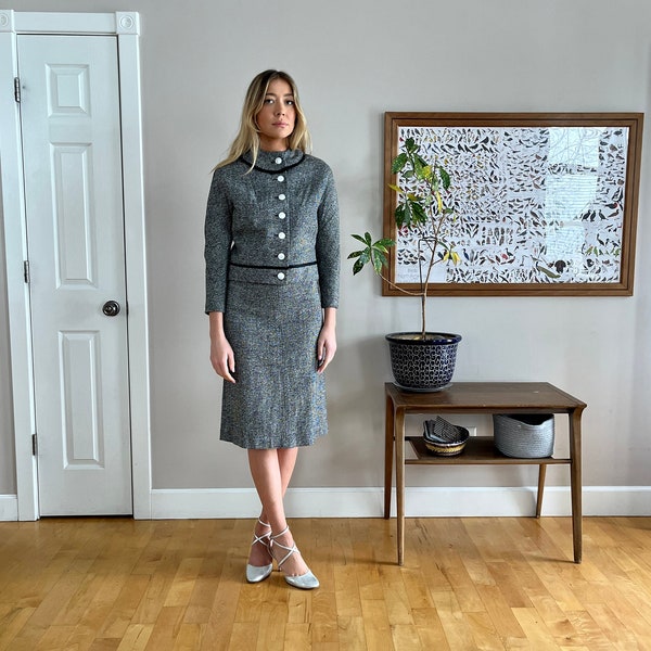 1950's 2-piece grey wool suit or skirt set, black trim w/ back bow, white pearly buttons stunning design excellent condition size XS or 0/2