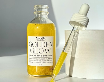 Aceite corporal con brillo dorado: aceite corporal con infusión de cristales y aroma a flor de naranjo.