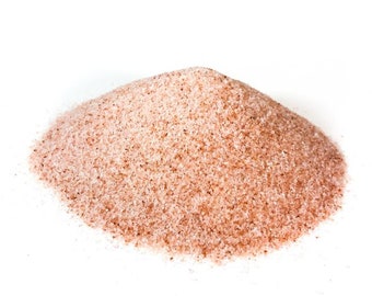 May include: A close-up of a pile of pink Himalayan salt crystals. The salt is fine-grained and has a light pink color.