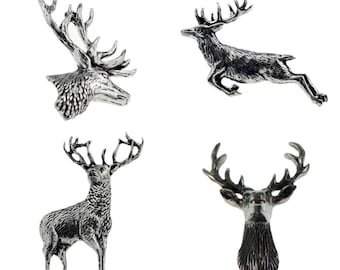 May include: A set of four silver-toned metal pins featuring deer motifs. The collection includes a deer head in profile, a leaping deer, a standing deer, and a front-facing deer head, all with detailed textures and polished metallic finishes.