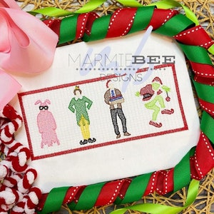 May include: Embroidered design featuring four characters from popular Christmas movies. The characters are Buddy the Elf, The Grinch, Clark Griswold, and a pink bunny wearing a mask. The design is on a white fabric with a red border.