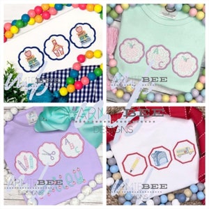 May include: Four different designs for embroidered iron-on patches for clothing. The designs include a schoolhouse, a stack of books, an apple, and a pencil. The patches are all in a circle shape with a pink outline.