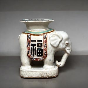 Asian White Glazed Porcelain Elephant Garden Seat 24” Tall Ceramic Stool w/ Saddle Motif Symbolizing Happiness & Prosperity, Upturned Trunk