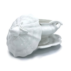 May include: White porcelain serving dish with a lid shaped like a cabbage. The dish has a scalloped edge and a handle on the side.
