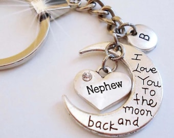May include: Silver keychain with a crescent moon charm that says "I love you to the moon and back" and a heart charm that says "Nephew".