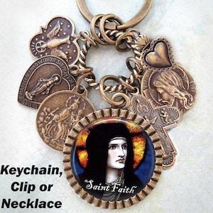 May include: A bronze charm necklace with a stained glass image of Saint Faith. The necklace features a variety of charms, including a heart, a cross, and a dove.