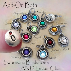 May include: A set of 12 silver charms with Swarovski birthstones and letter charms. Each charm features a different birthstone color and a letter of the alphabet. The charms are arranged in a circle with the month names written around the outside.