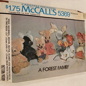 May include: A vintage McCall's 5369 sewing pattern envelope. The pattern includes instructions for creating stuffed animals, such as a wolf, squirrel, mouse, skunk, rabbit, and woodchuck, each approximately 25cm to 32cm tall. The envelope reads "A FOREST FAMILY".
