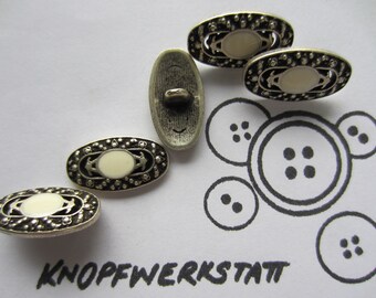 May include: Five silver oval buttons with white centers and decorative edges. The buttons have a textured surface and a small loop on the back for sewing.