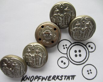 May include: Six silver-toned metal buttons with a raised design of two people in traditional clothing. The buttons have a slightly aged look and are arranged in a semi-circle on a white surface.