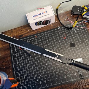 May include: A white ceramic mug with a black handle and the text "But First, Coffee" in a black, bold font. The mug is on a white surface. The mug is 4 inches tall.