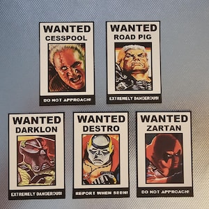 May include: Five rectangular "Wanted" posters featuring comic book characters. Each poster has a portrait of a character and the name of the character. The posters have the following text: "Do Not Approach!", "Extremely Dangerous!", and "Report When Seen!"