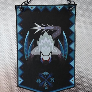 May include: A black banner with a blue and white border features a stylized image of a white monster with a blue tail and wings. The monster has a red eye and a black mouth. The banner has a chain attached to the top for hanging.
