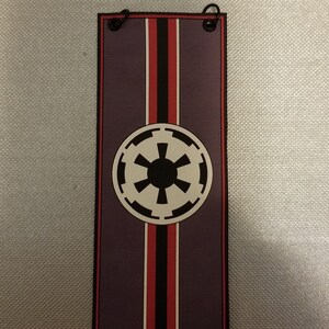 May include: A purple banner with a black and white Imperial symbol and red and black stripes.