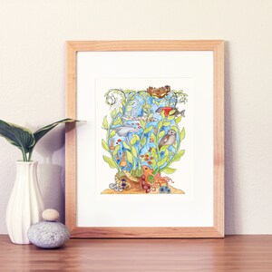 May include: A watercolour painting of a whimsical underwater scene with a variety of sea creatures, including a dolphin, a seal, an octopus, and various fish. The scene is framed in a light wood frame.