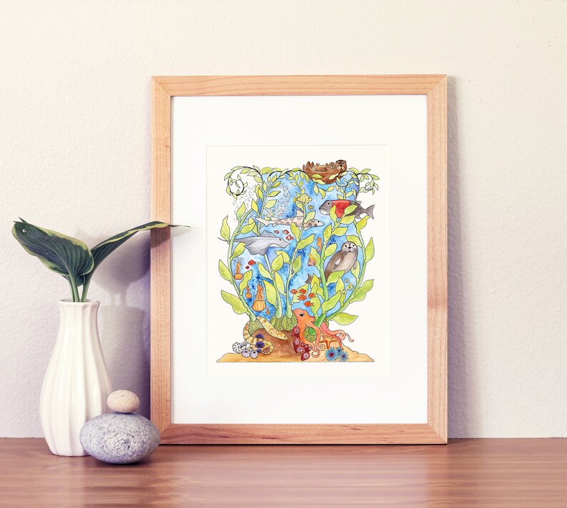 May include: A watercolour painting of a whimsical underwater scene with a variety of sea creatures, including a dolphin, a seal, an octopus, and various fish. The scene is framed in a light wood frame.