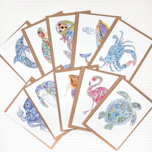 Set of Coastal themed notecards, featuring a whale, sea otter, sea turtles, manatee, mermaid, flamingo, blue crab, dolphin and octopus