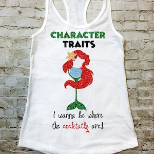 May include: White tank top with a green and black "Character Traits" text, a red glitter mermaid silhouette holding a martini glass, and the text "I wanna be where the cocktails are!"